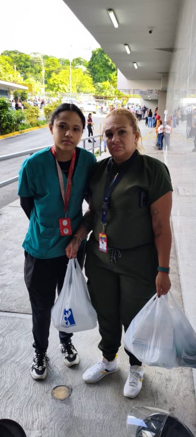 Volunteers delivering supplies at a hospital entrance.