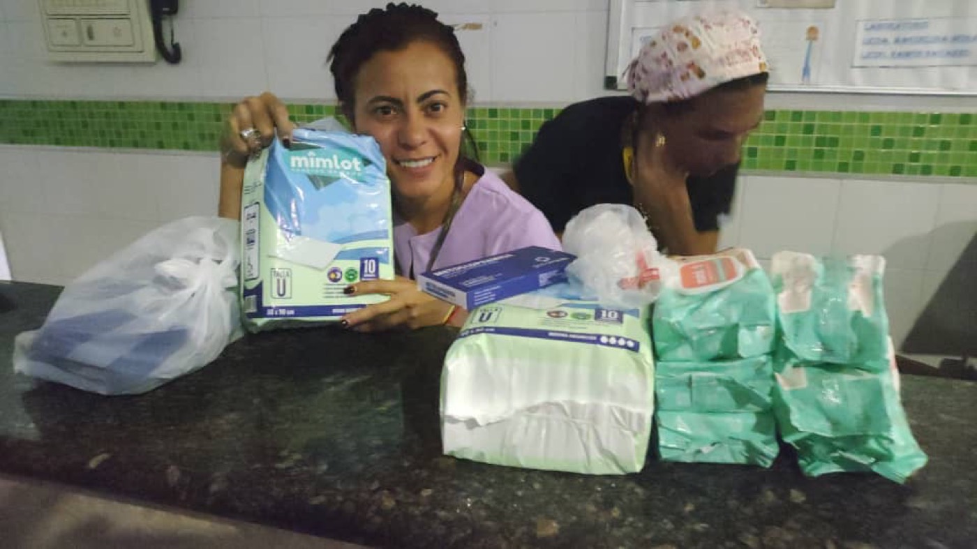 Health staff receiving donated diapers and supplies.